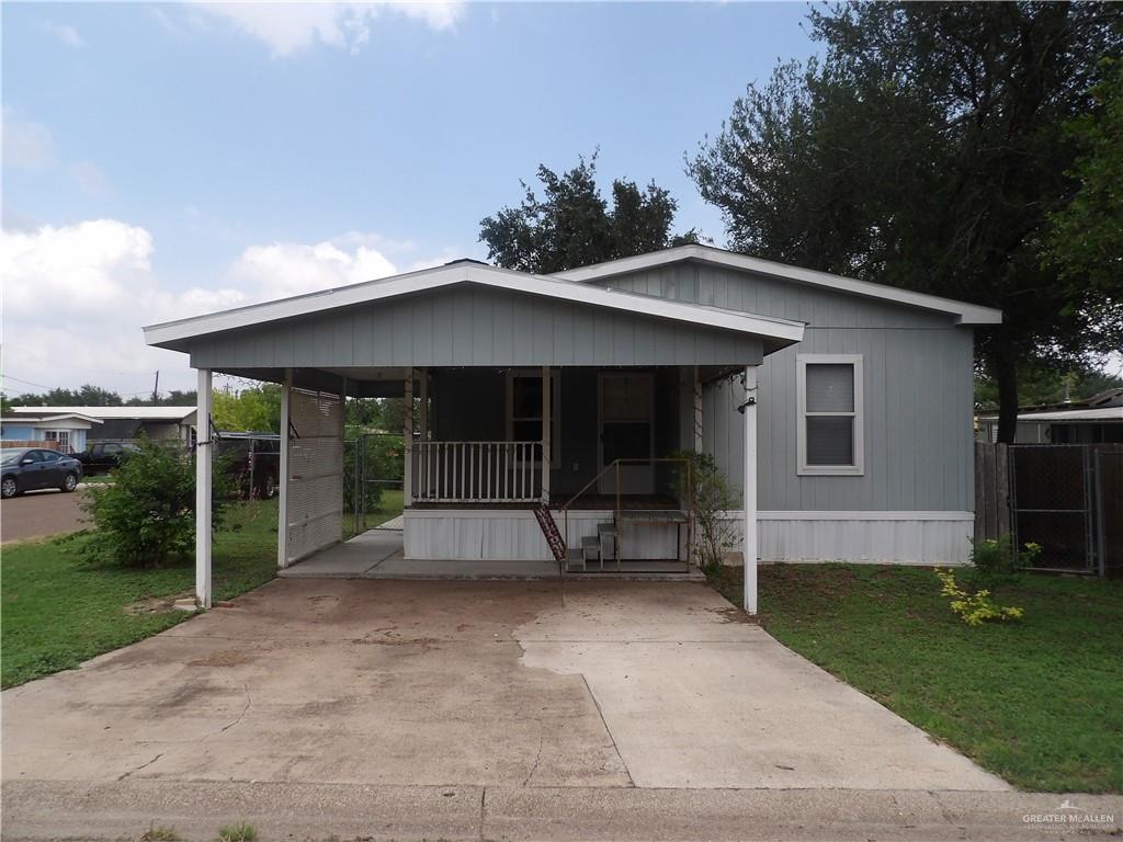 1406 West Ray Circle Mission, TX 78572 - Photo 1 of 22 a view of house with backyard and outdoor seating
