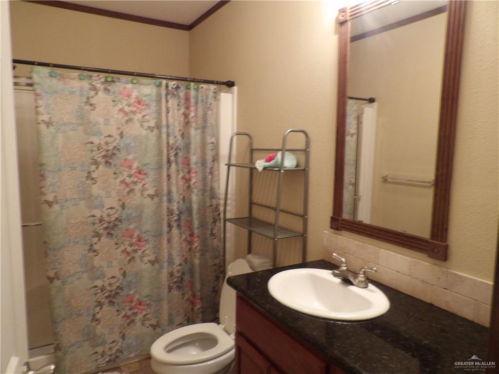 1406 West Ray Circle Mission, TX 78572 - Photo 13 of 22 a bathroom with a sink toilet and shower