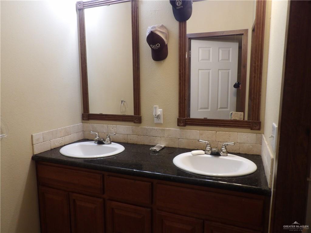 1406 West Ray Circle Mission, TX 78572 - Photo 16 of 22 a bathroom with a sink and a mirror