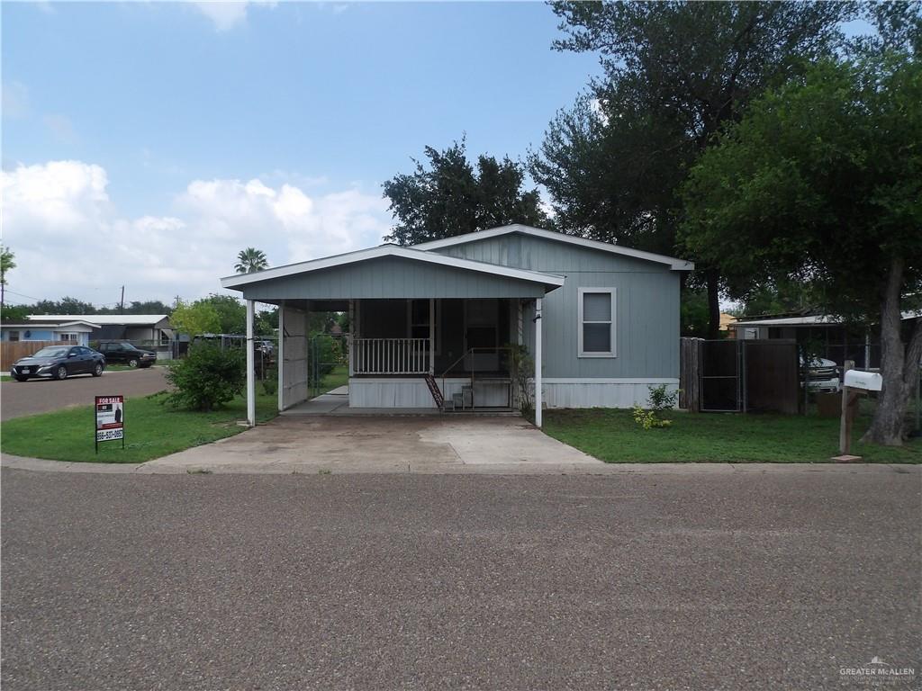 1406 West Ray Circle Mission, TX 78572 - Photo 2 of 22 a view of a house with a yard and potted plants