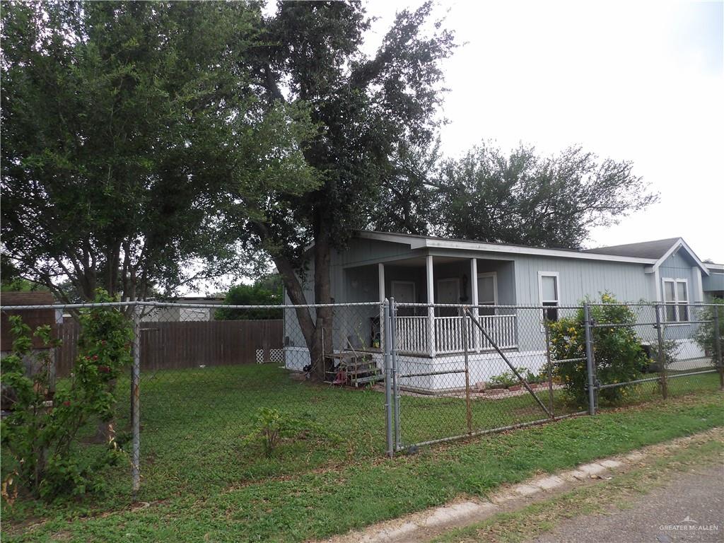 1406 West Ray Circle Mission, TX 78572 - Photo 4 of 22 a view of a backyard with potted plants and large tree