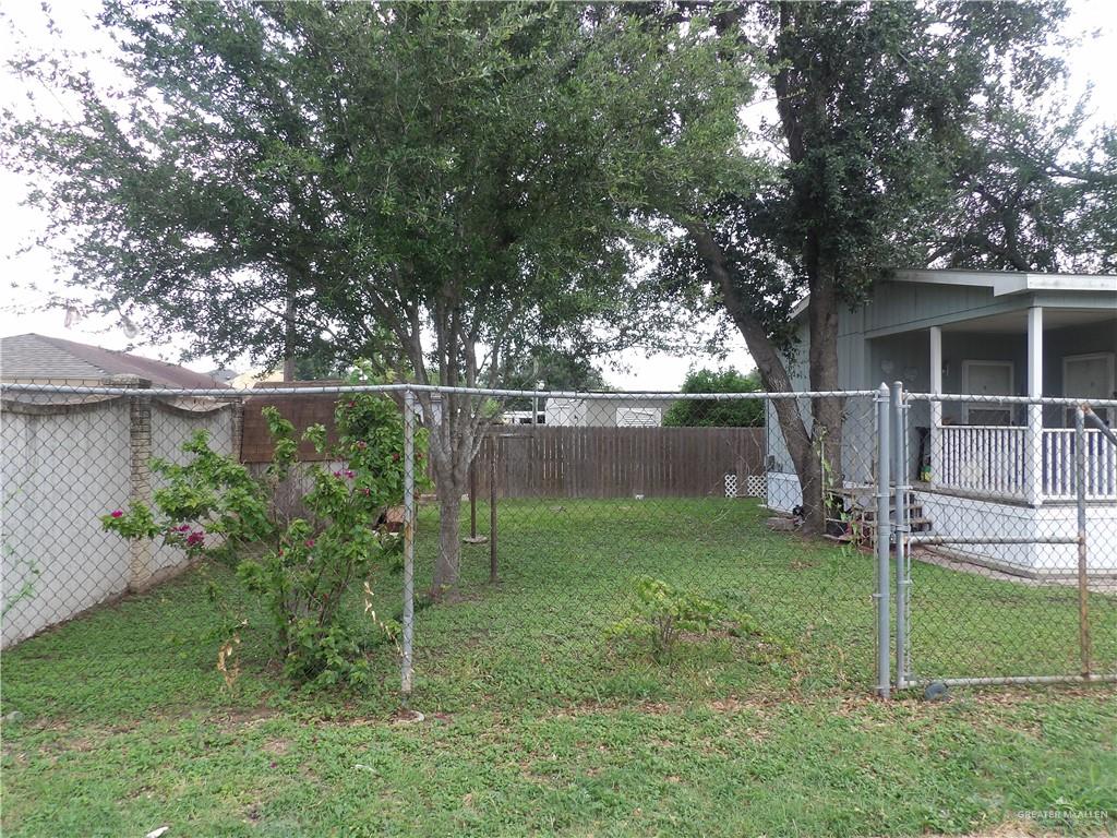 1406 West Ray Circle Mission, TX 78572 - Photo 5 of 22 a backyard of a house with plants and large tree