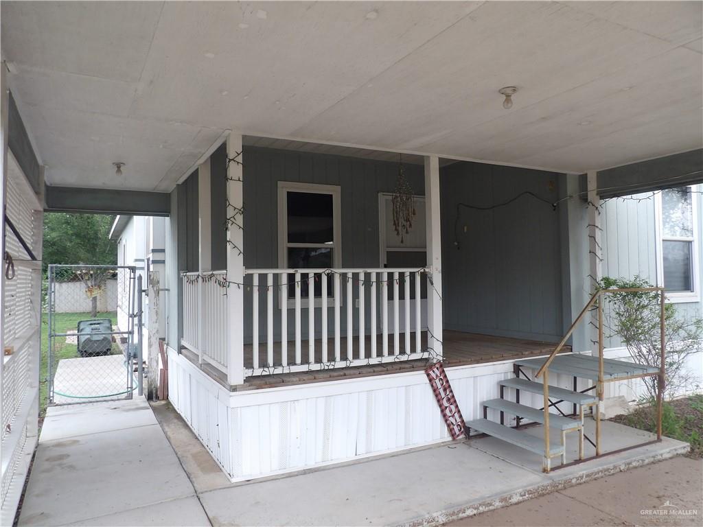 1406 West Ray Circle Mission, TX 78572 - Photo 6 of 22 a view of backyard with a large grill and wooden fence