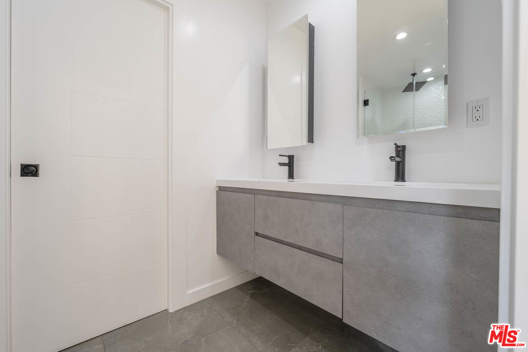 1216 Peck Drive Los Angeles, CA 90035 - Photo 16 of 29 a bathroom with a sink and a mirror