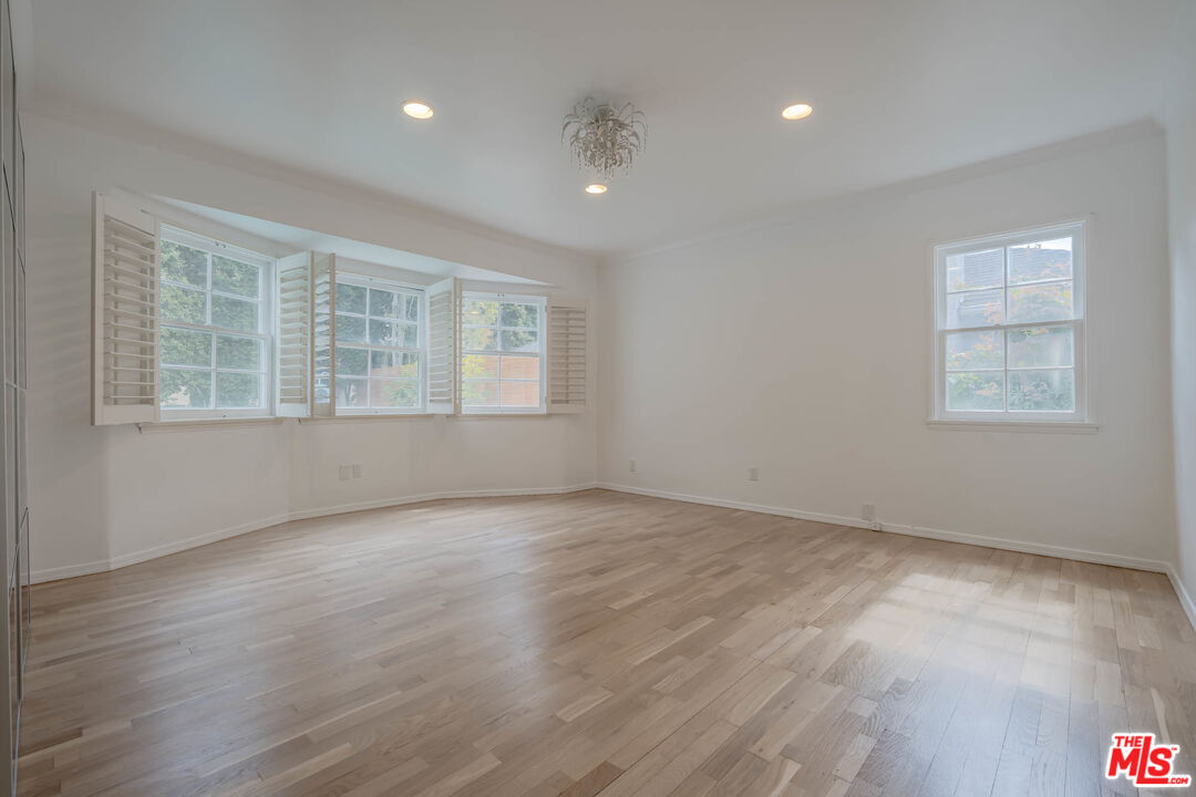 1216 Peck Drive Los Angeles, CA 90035 - Photo 20 of 29 an empty room with wooden floor and windows