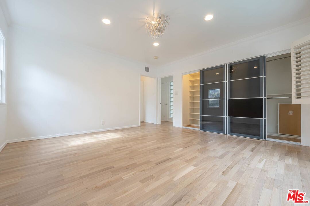 1216 Peck Drive Los Angeles, CA 90035 - Photo 21 of 29 a view of empty room with wooden floor and fan