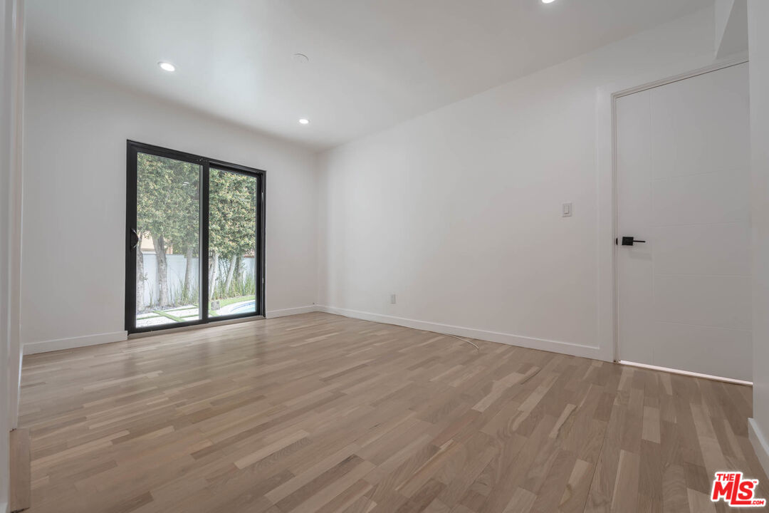 1216 Peck Drive Los Angeles, CA 90035 - Photo 25 of 29 a view of an empty room with wooden floor and a window