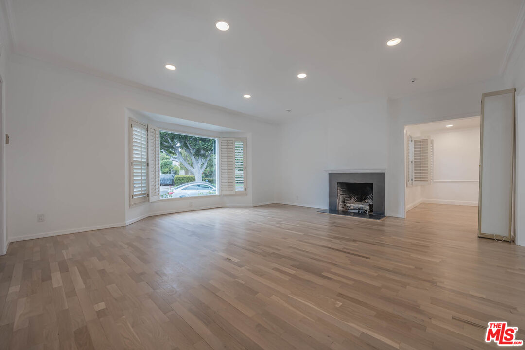1216 Peck Drive Los Angeles, CA 90035 - Photo 4 of 29 a view of an empty room with wooden floor and a window