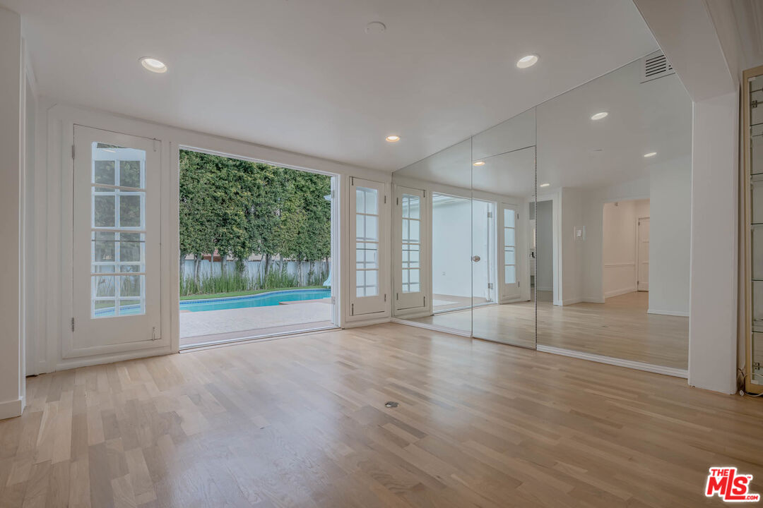 1216 Peck Drive Los Angeles, CA 90035 - Photo 6 of 29 a view of an empty room with wooden floor and a window