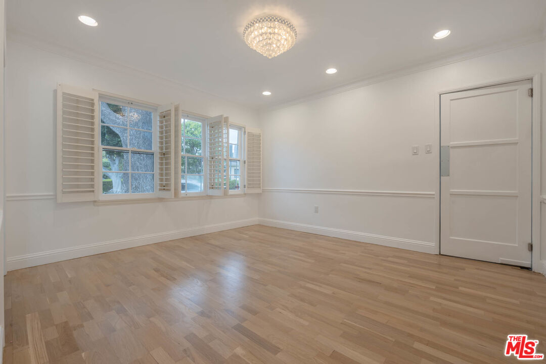 1216 Peck Drive Los Angeles, CA 90035 - Photo 9 of 29 an empty room with wooden floor and windows