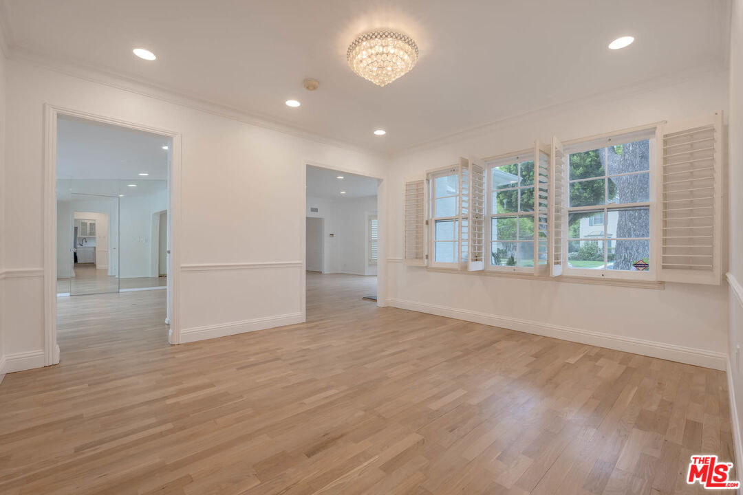 1216 Peck Drive Los Angeles, CA 90035 - Photo 10 of 29 a view of an empty room with a window and wooden floor