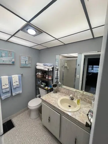 a bathroom with a sink toilet and shower