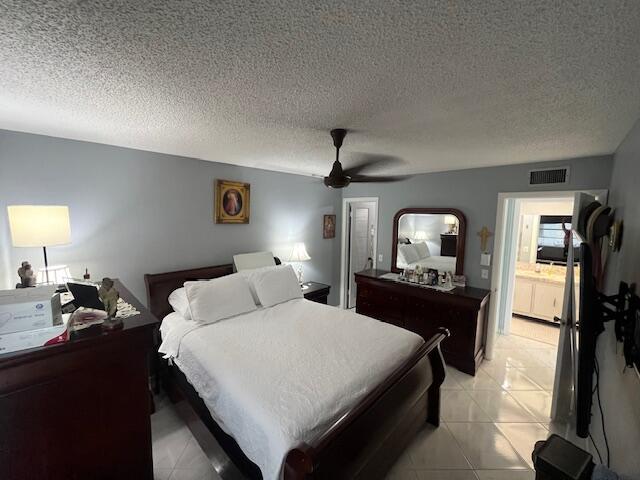 897 Flanders South, Unit 897 Delray Beach, FL 33484 - Photo 6 of 17 a bedroom with a bed and a dresser with mirror