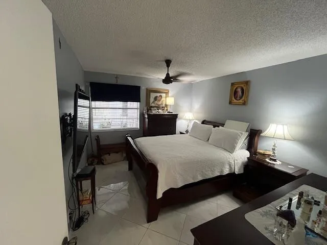 a bed room with a bed window and dresser