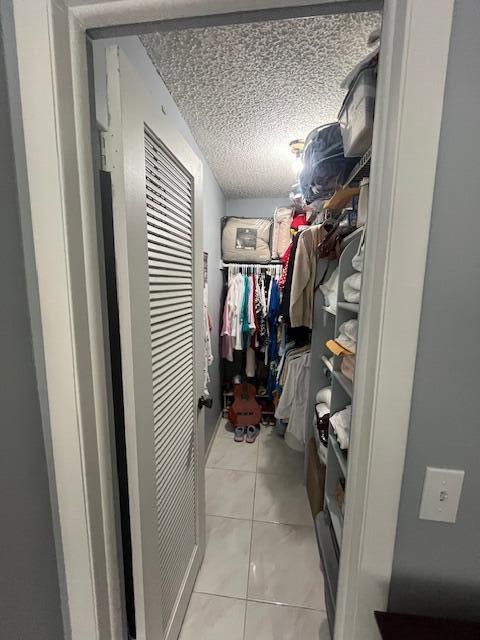 897 Flanders South, Unit 897 Delray Beach, FL 33484 - Photo 8 of 17 a view of walk in closet with clothes