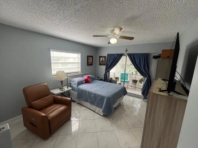 a living room with furniture a window and a flat screen tv