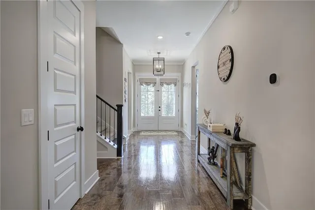 a kitchen with stainless steel appliances granite countertop a stove a refrigerator a kitchen island a dining table and chairs with wooden floor