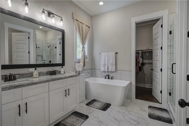 a spacious bathroom with a granite countertop sink and a mirror