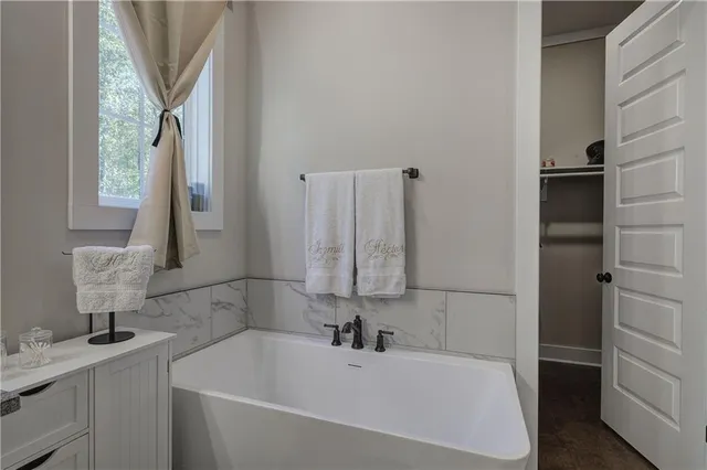 a bathroom with a bathtub a shower a toilet and sink