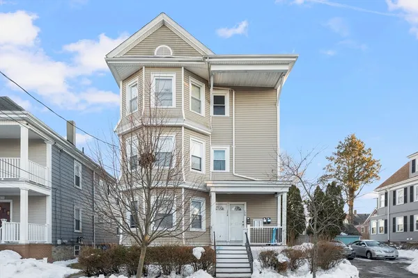 a front view of a residential apartment building with a yard
