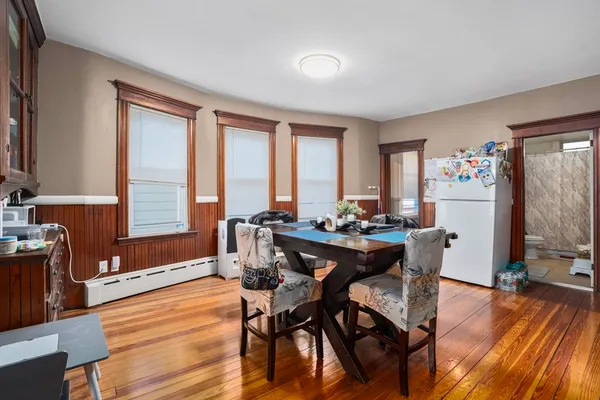 a view of a dining room with furniture window and wooden floor