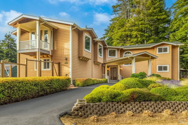 a front view of house with yard and green space