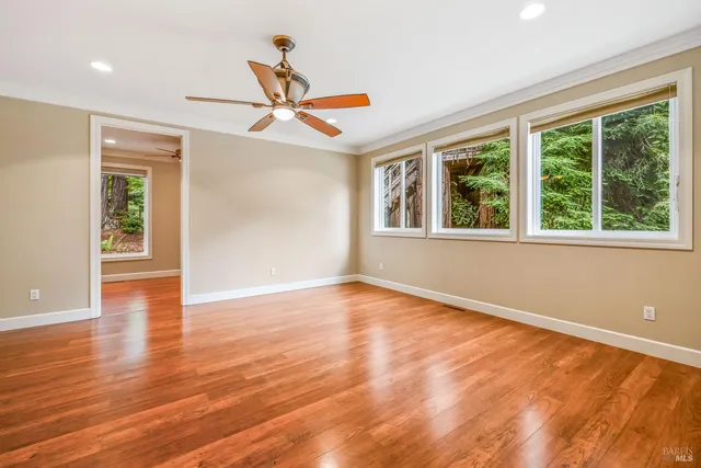 a view of a room with wooden floor and window