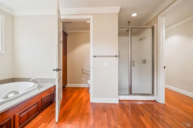 a spacious bathroom with a granite countertop sink and a bathtub