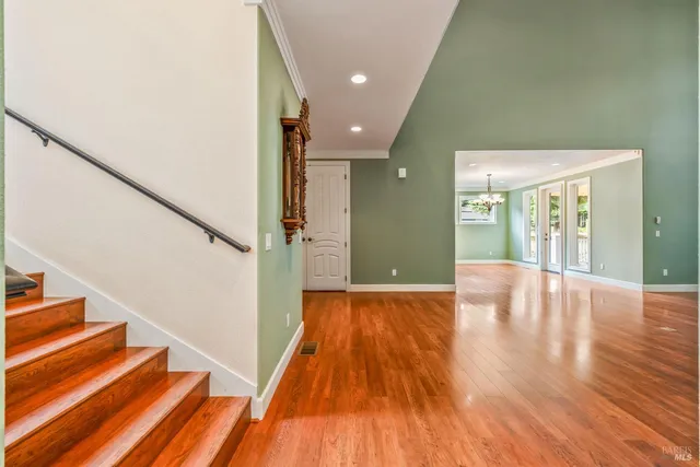 a view of a room with wooden floor and a window