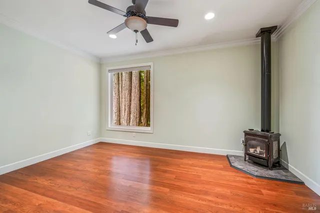 a view of a house with a small yard and wooden fence