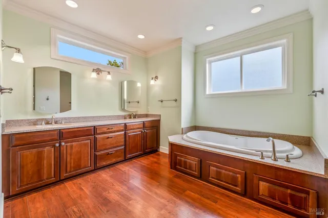 a roof deck with table and chairs under an umbrella