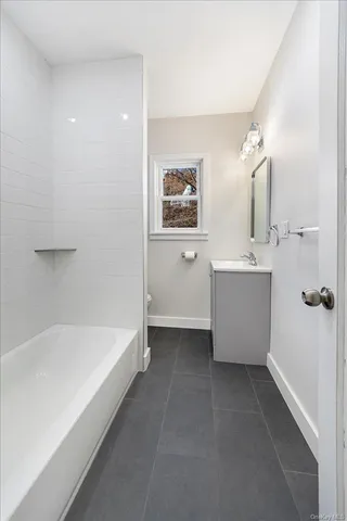 a bathroom with a bathtub and sink