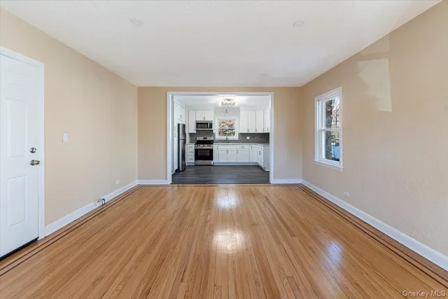 a view of a kitchen with wooden floor and electronic appliances