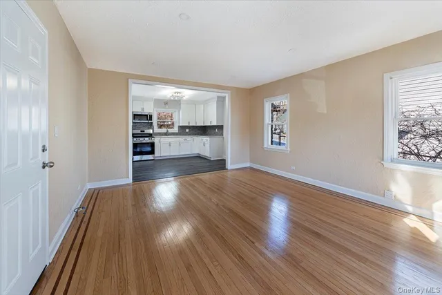 a view of a room with wooden floor and window