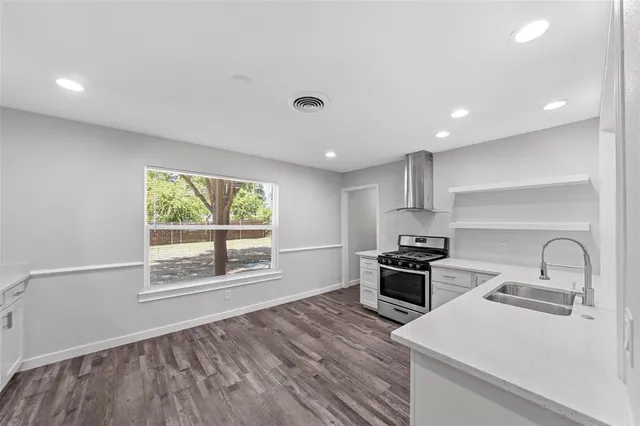 a kitchen with a refrigerator and window