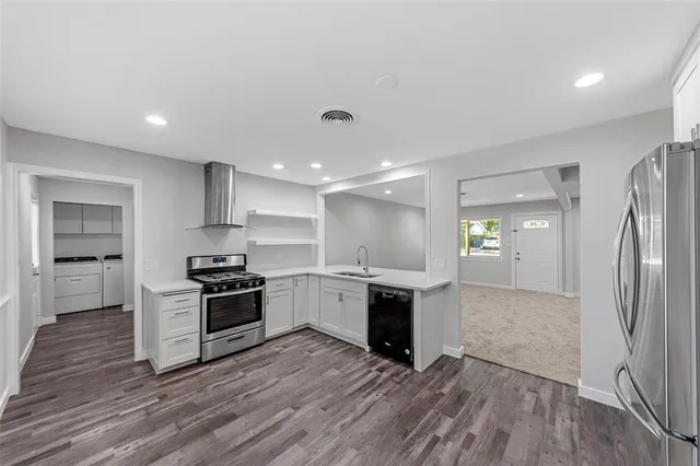 a kitchen with stainless steel appliances a refrigerator sink and stove