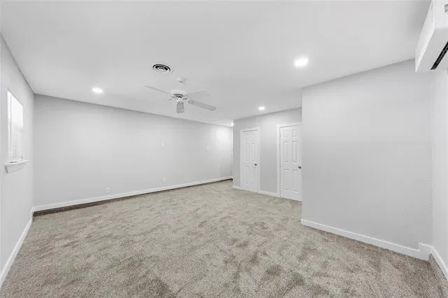 a spacious bedroom with a bed and painting on the wall