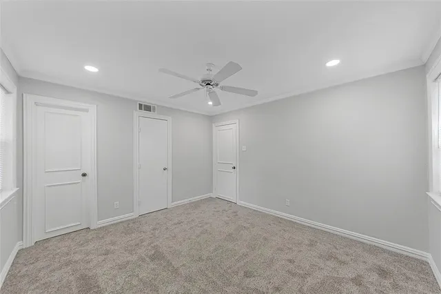 an empty room with windows and closet