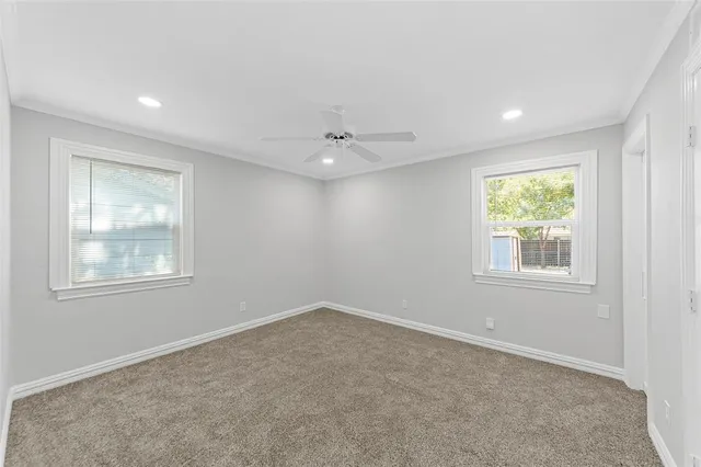 a view of a tree in front of a white house