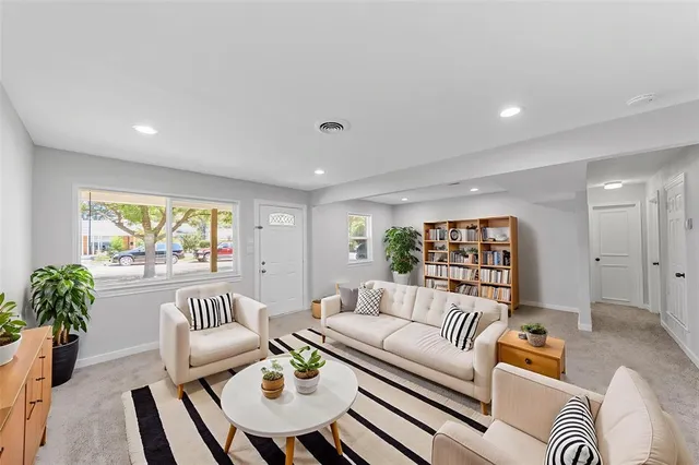 a living room with furniture and a large window