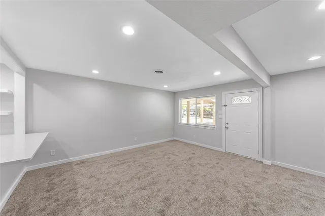 an empty room with windows and closet