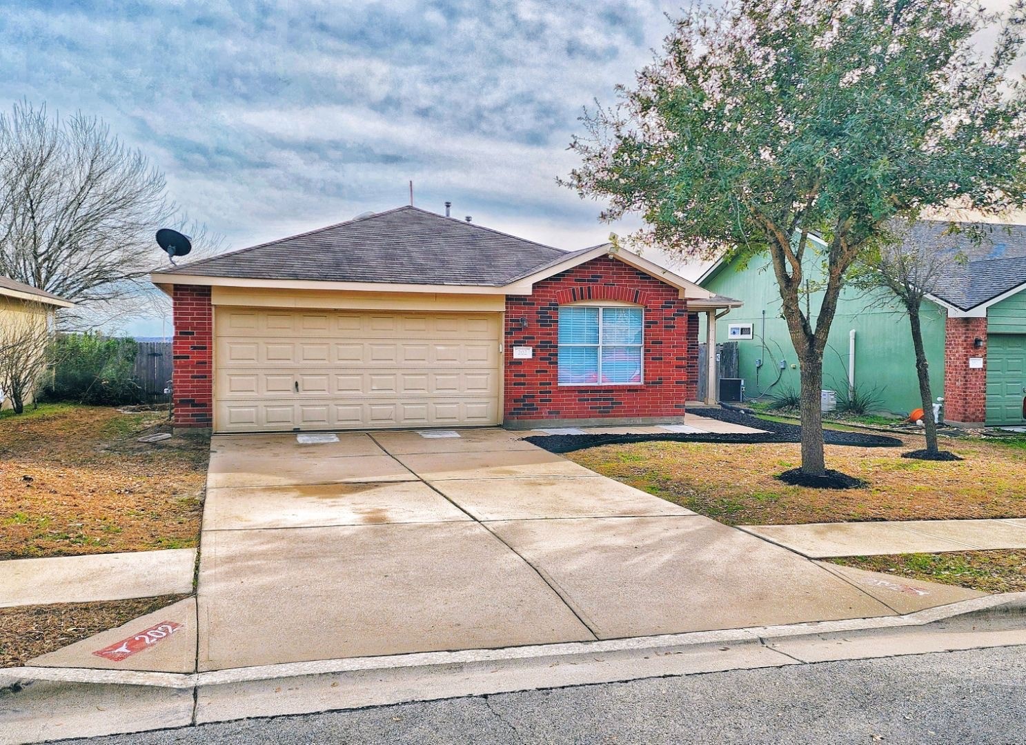 202 Brandons Way Buda, TX 78610 - Photo 1 of 16 a front view of a house with a yard and garage