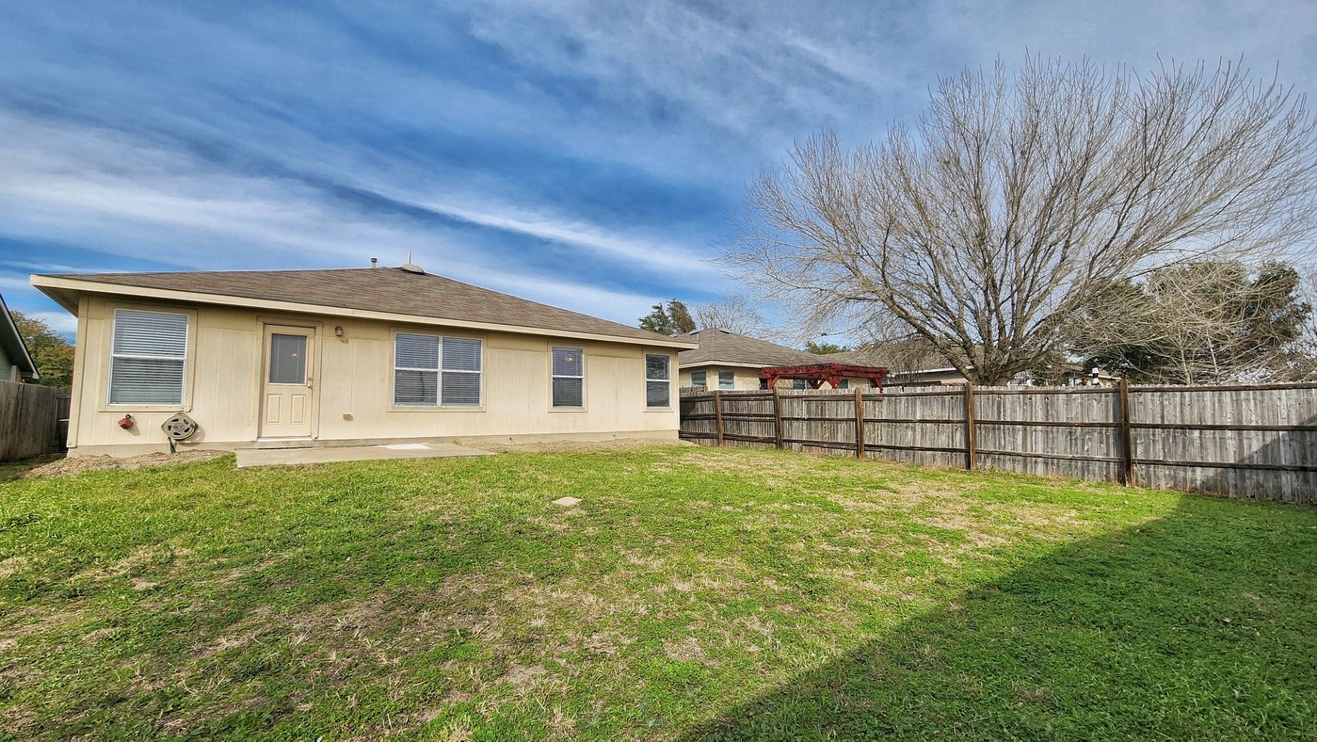 202 Brandons Way Buda, TX 78610 - Photo 15 of 16 a backyard of a house with table and chairs