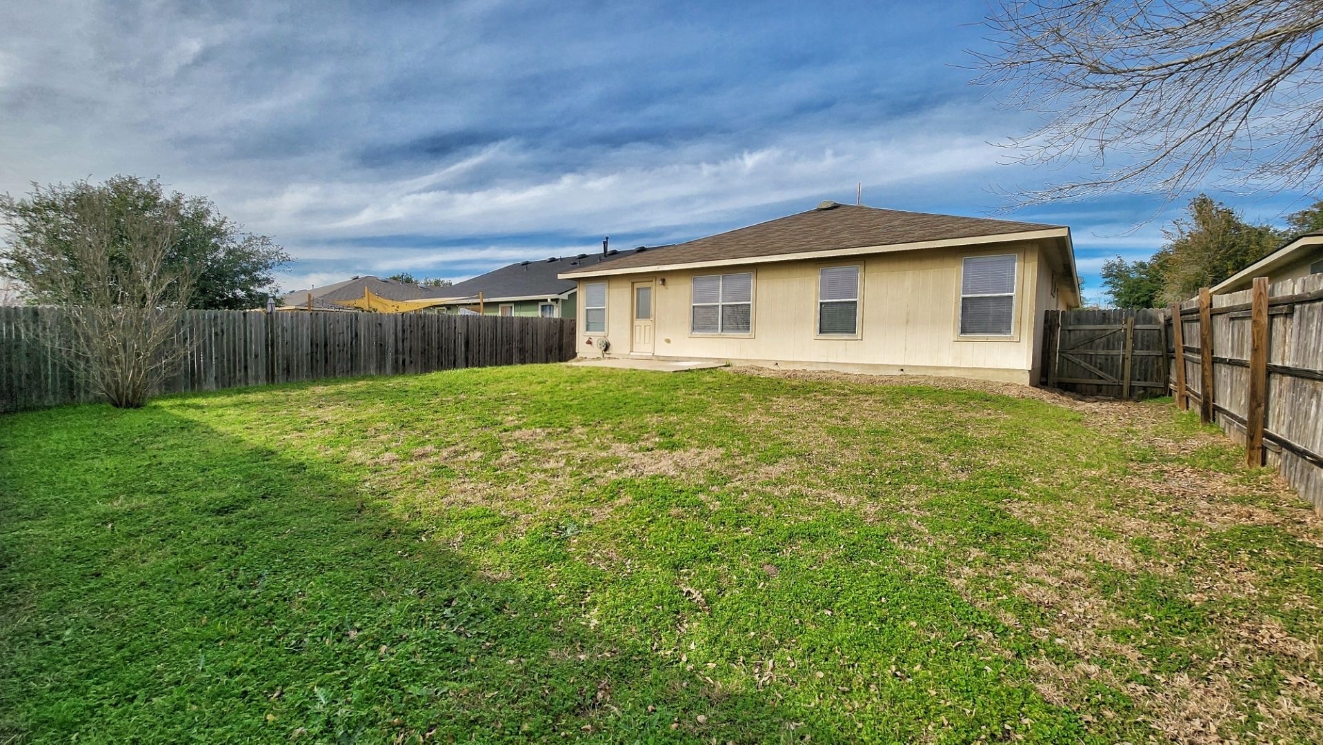 202 Brandons Way Buda, TX 78610 - Photo 16 of 16 a house with huge green field in front of it