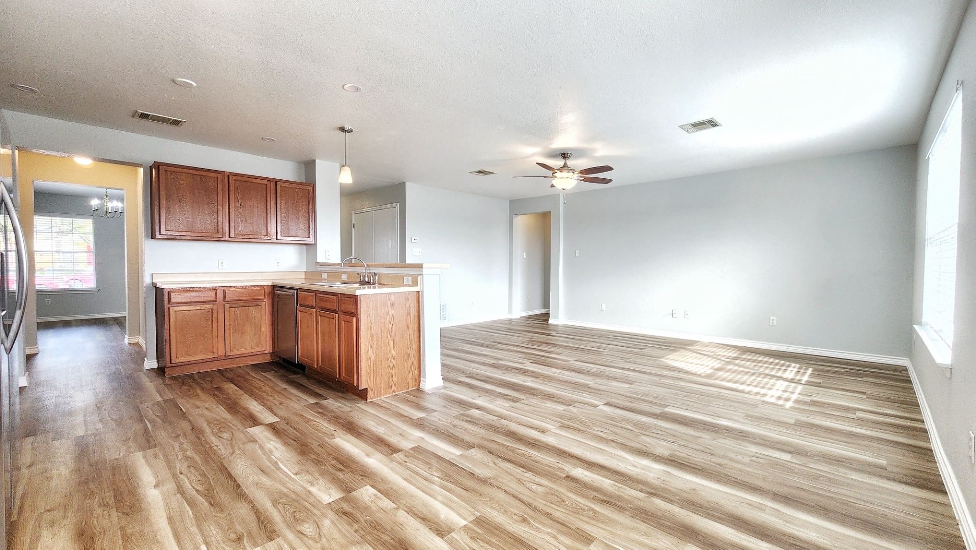 202 Brandons Way Buda, TX 78610 - Photo 4 of 16 a view of a kitchen with a sink cabinets and wooden floor