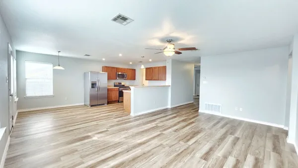 a view of a kitchen with a sink and a window