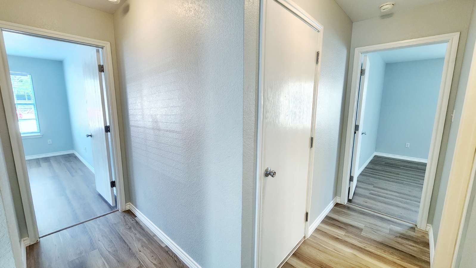 202 Brandons Way Buda, TX 78610 - Photo 7 of 16 a view of a hallway with wooden floor and staircase