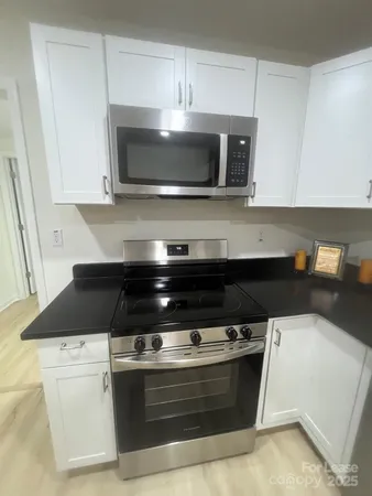 a stove top oven sitting inside of a kitchen