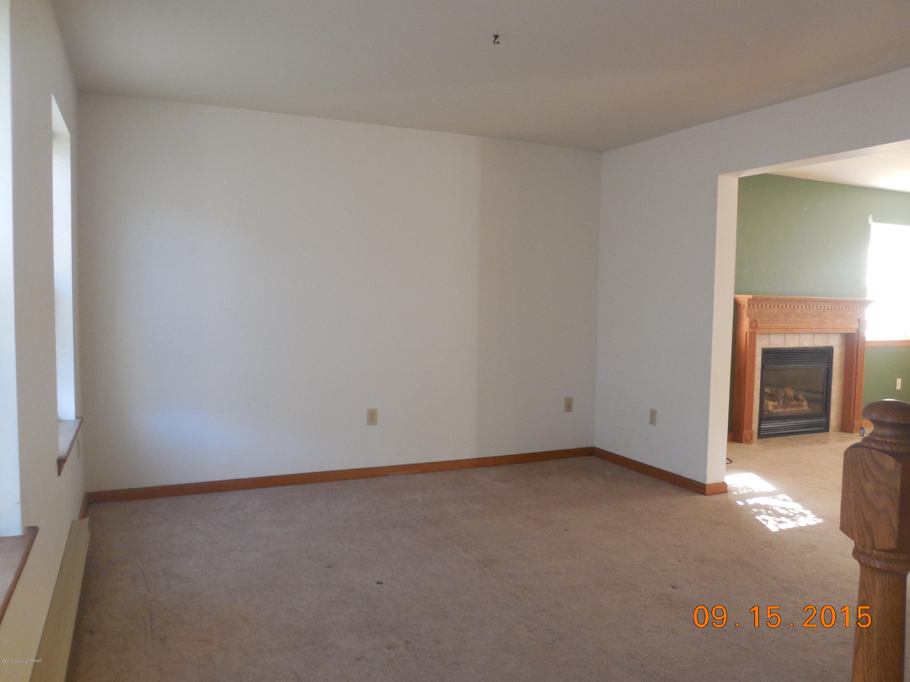 2216 Hill Road Effort, PA 18330 - Photo 2 of 11 an empty room with a fireplace