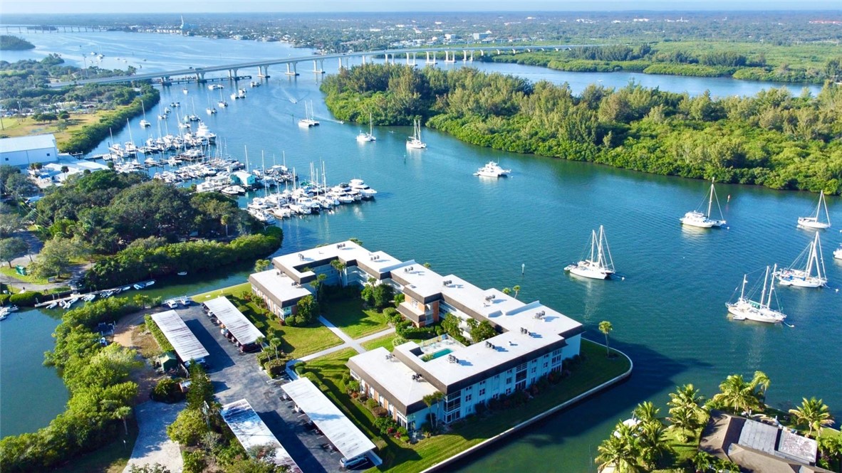 an aerial view of lake with residential houses with outdoor space